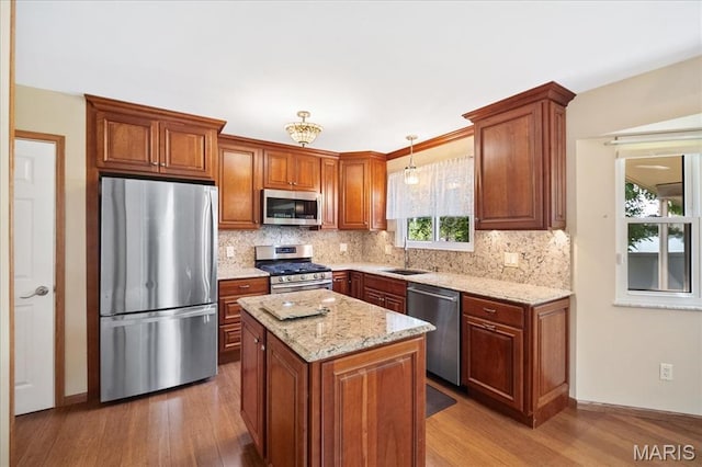 221 Greiner Ct, Ellisville, MO 63021 - kitchen featuring appliances with stainless steel finishes, wood finished floors, and backsplash