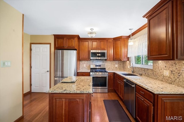 221 Greiner Ct, Ellisville, MO 63021 - kitchen with stainless steel appliances, decorative backsplash, light wood-style flooring, and light stone counters