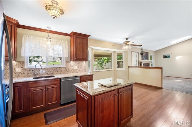 221 Greiner Ct, Ellisville, MO 63021 - kitchen with stainless steel appliances, wood finished floors, tasteful backsplash, a ceiling fan, and decorative light fixtures