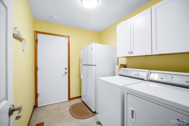 221 Greiner Ct, Ellisville, MO 63021 - laundry area with cabinet space, washer and clothes dryer, and light tile patterned flooring