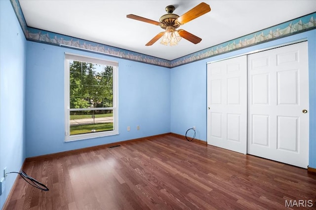 221 Greiner Ct, Ellisville, MO 63021 - unfurnished bedroom with wood finished floors, a closet, and a ceiling fan