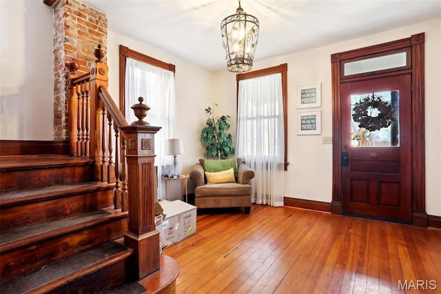 502 W 5th St, Washington, MO 63090 - foyer with wood-type flooring, a chandelier, stairway, and baseboards