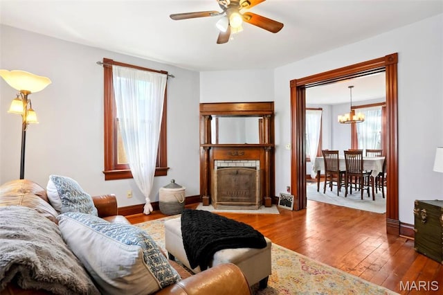 502 W 5th St, Washington, MO 63090 - living room with healthy amount of natural light, ceiling fan, a fireplace with flush hearth, and hardwood / wood-style flooring