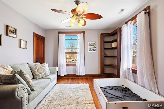 502 W 5th St, Washington, MO 63090 - living area featuring ceiling fan, wood finished floors, and baseboards