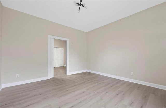spare room featuring wood finished floors and baseboards