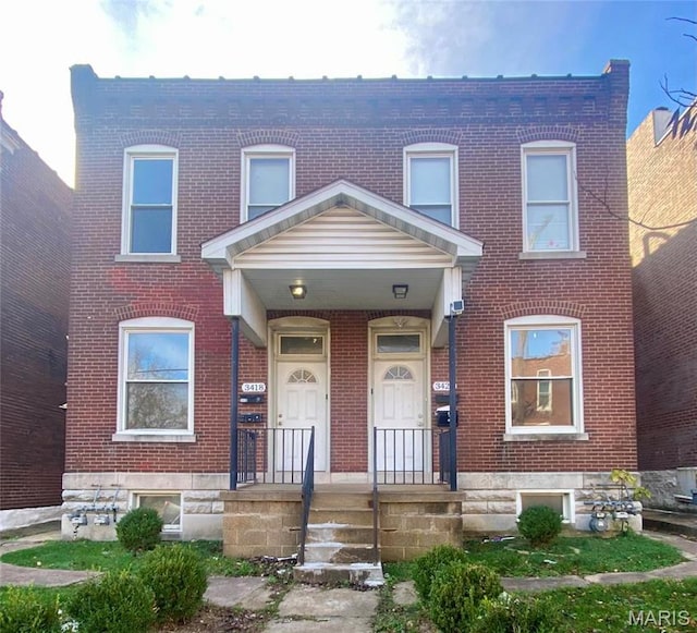 view of property with brick siding