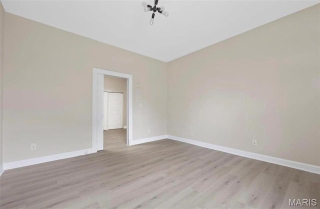 spare room with wood finished floors and baseboards
