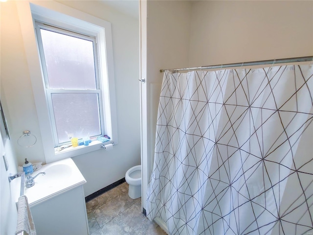 full bathroom with toilet, vanity, and curtained shower