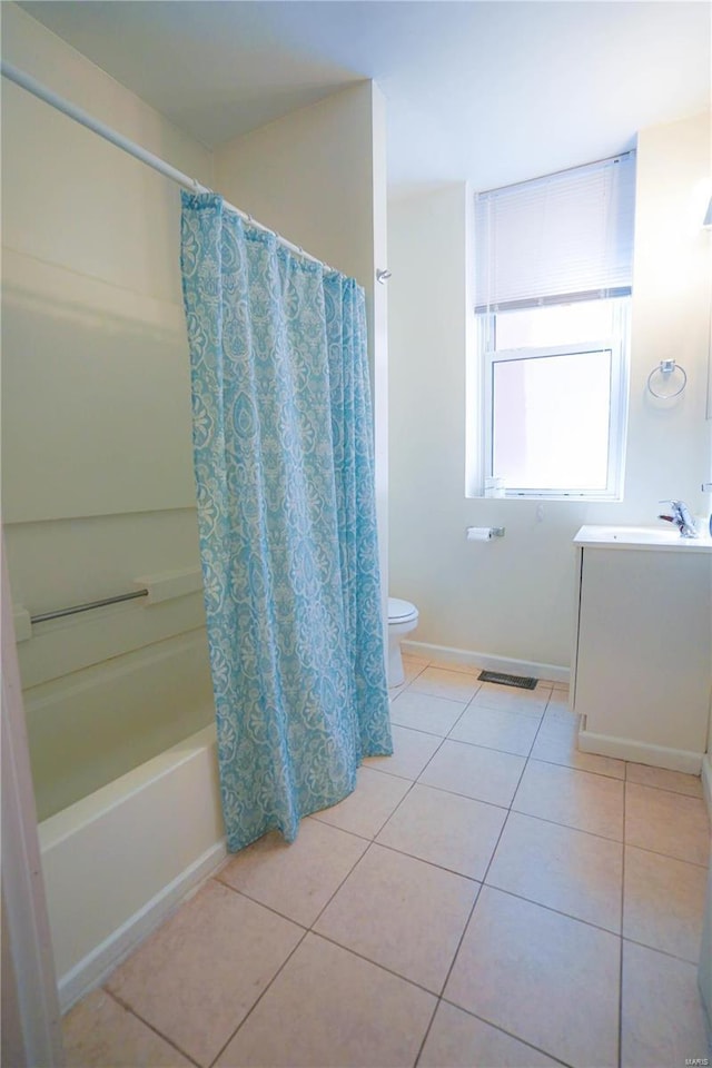 bathroom with tile patterned floors, toilet, vanity, shower / bath combo with shower curtain, and baseboards