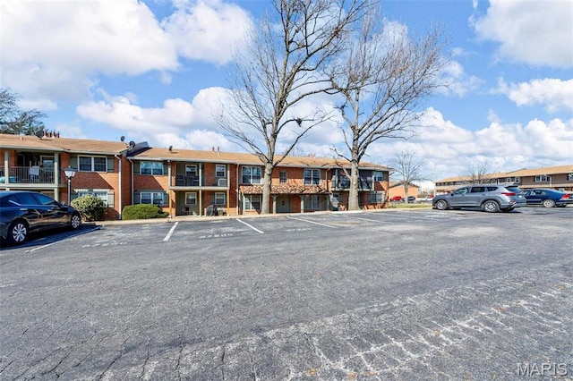 8724 Santa Bella Dr Unit G, Hazelwood, MO 63042 - uncovered parking lot featuring a residential view