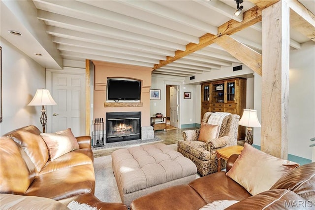 507 Leach Branch Rd, Hermann, MO 65041 - living room with beam ceiling, a glass covered fireplace, and baseboards