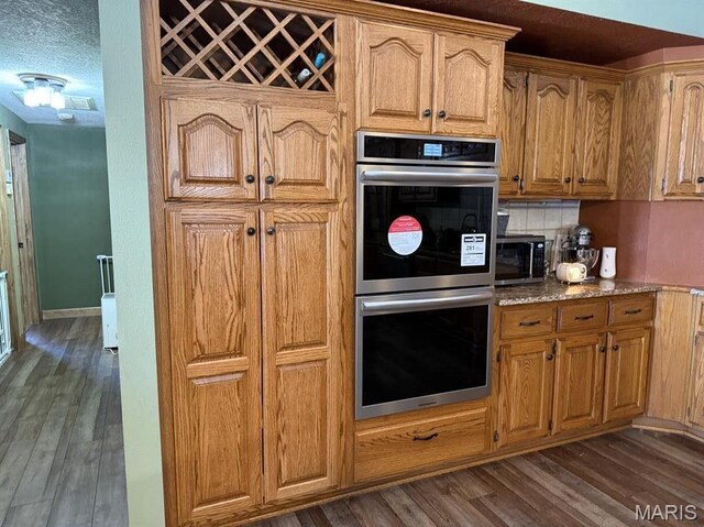 27409 Missouri Dr, Lebanon, MO 65536 - kitchen with appliances with stainless steel finishes, dark wood-style floors, backsplash, and light stone countertops