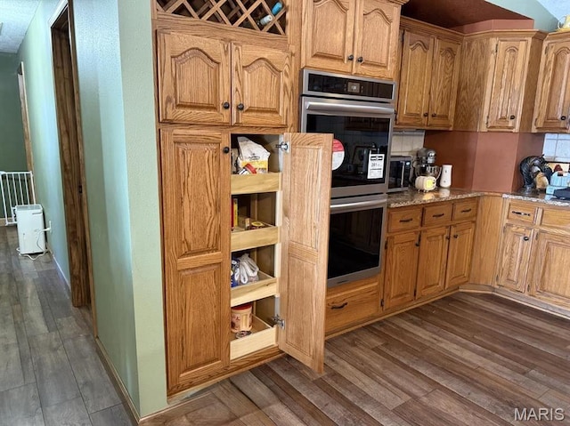 27409 Missouri Dr, Lebanon, MO 65536 - kitchen with double oven, dark wood-type flooring, and light stone counters