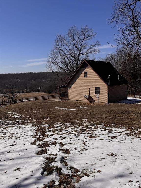 27409 Missouri Dr, Lebanon, MO 65536 - snow covered property with fence, an outbuilding, and a barn