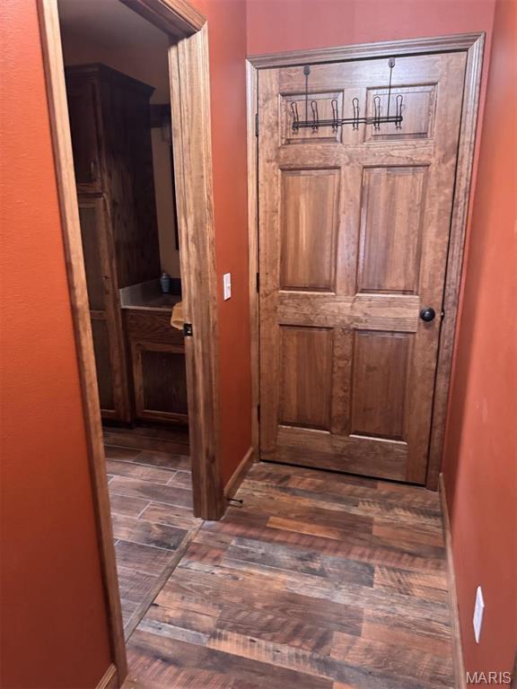 27409 Missouri Dr, Lebanon, MO 65536 - corridor featuring dark wood-type flooring and baseboards