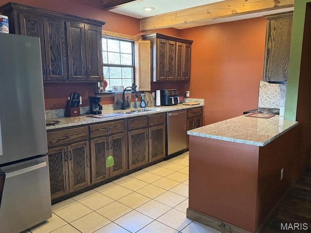27409 Missouri Dr, Lebanon, MO 65536 - kitchen featuring appliances with stainless steel finishes, a sink, backsplash, light tile patterned floors, and light stone counters