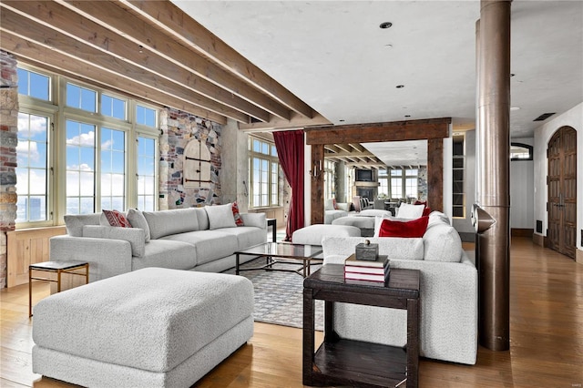 150 Carondelet Unit 2901, Saint Louis, MO 63105 - living area featuring ornate columns, wood finished floors, and plenty of natural light