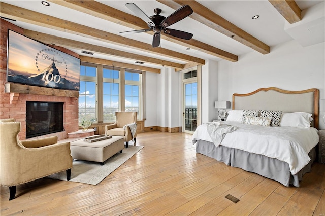 150 Carondelet Unit 2901, Saint Louis, MO 63105 - bedroom with beam ceiling, light wood-type flooring, access to outside, a fireplace, and baseboards