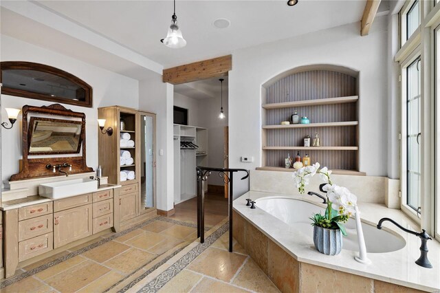 150 Carondelet Unit 2901, Saint Louis, MO 63105 - full bathroom featuring stone tile flooring, plenty of natural light, vanity, and a bath