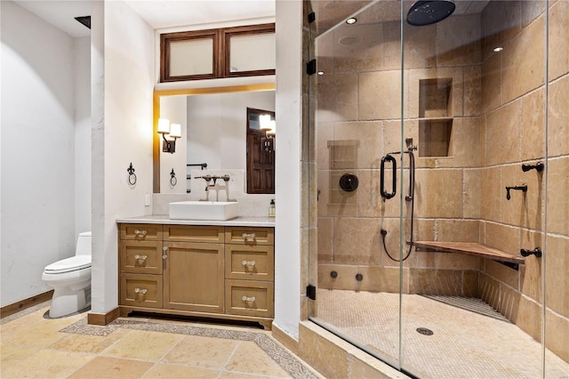 150 Carondelet Unit 2901, Saint Louis, MO 63105 - bathroom featuring a shower stall, baseboards, toilet, vanity, and stone tile floors