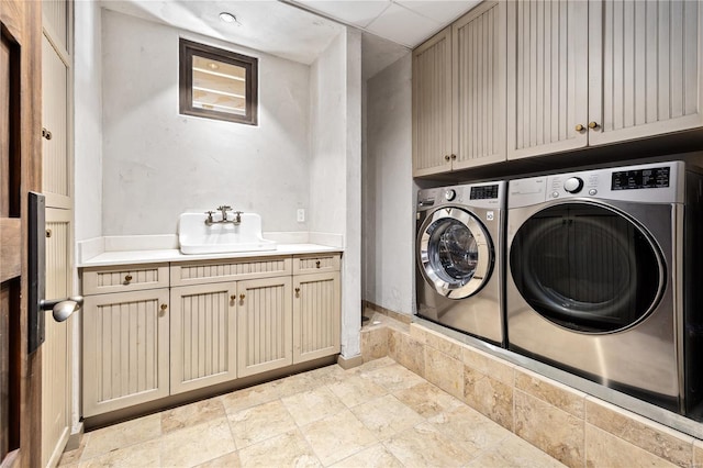 150 Carondelet Unit 2901, Saint Louis, MO 63105 - laundry area featuring cabinet space, washing machine and clothes dryer, and stone tile floors