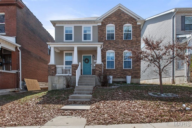3208 Henrietta St, Saint Louis, MO 63104 - view of front of property with brick siding and a porch