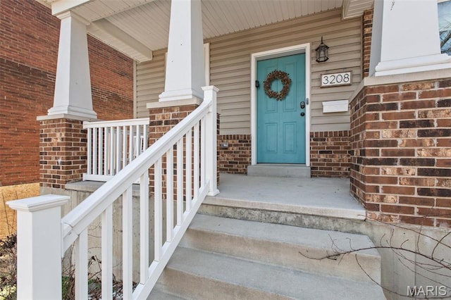 3208 Henrietta St, Saint Louis, MO 63104 - doorway to property with brick siding and a porch