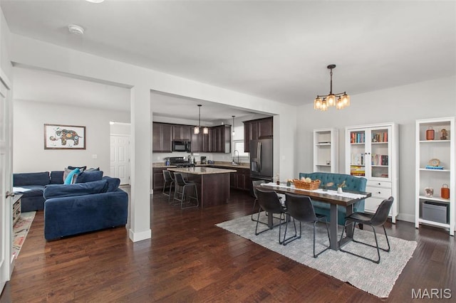 3208 Henrietta St, Saint Louis, MO 63104 - dining area with a chandelier and dark wood-type flooring