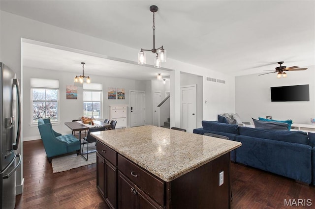 3208 Henrietta St, Saint Louis, MO 63104 - kitchen with stainless steel refrigerator with ice dispenser, open floor plan, dark wood-type flooring, and dark brown cabinets