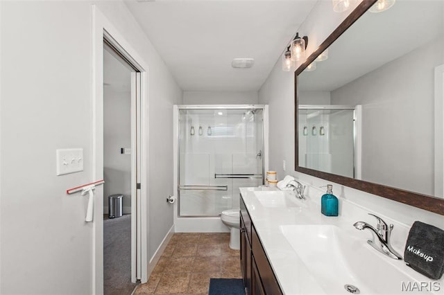 3208 Henrietta St, Saint Louis, MO 63104 - bathroom featuring an enclosed shower, double vanity, baseboards, and toilet