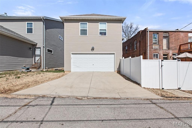3208 Henrietta St, Saint Louis, MO 63104 - view of side of property with an attached garage, entry steps, fence, and concrete driveway