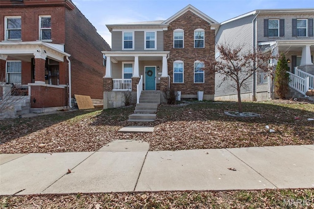3208 Henrietta St, Saint Louis, MO 63104 - view of front facade featuring covered porch, brick siding, and stairs