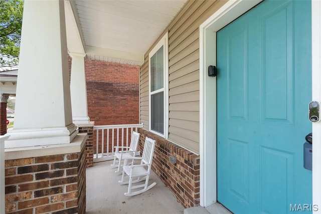 3208 Henrietta St, Saint Louis, MO 63104 - doorway to property with a porch and brick siding