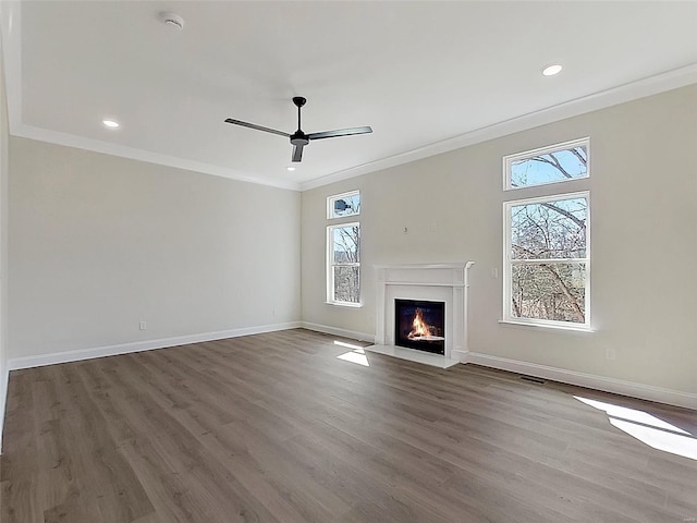 220 Great Bear Pass, Foristell, MO 63348 - unfurnished living room featuring ornamental molding, wood finished floors, a ceiling fan, baseboards, and a fireplace with flush hearth