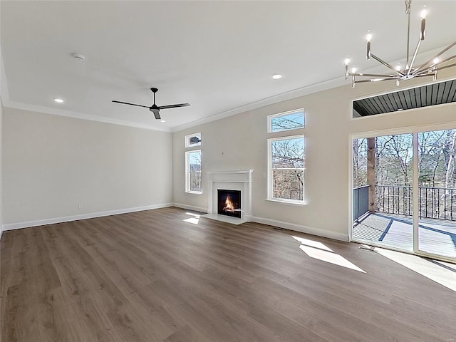 220 Great Bear Pass, Foristell, MO 63348 - unfurnished living room featuring ornamental molding, baseboards, dark wood-style floors, a chandelier, and a fireplace with flush hearth
