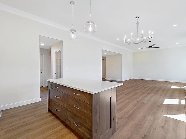220 Great Bear Pass, Foristell, MO 63348 - kitchen with a chandelier, light wood finished floors, light countertops, baseboards, and decorative light fixtures