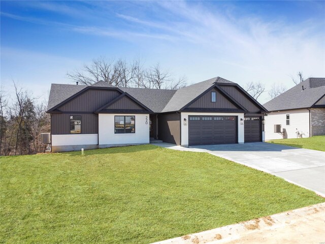 220 Great Bear Pass, Foristell, MO 63348 - modern inspired farmhouse featuring a shingled roof, driveway, a garage, and a front lawn