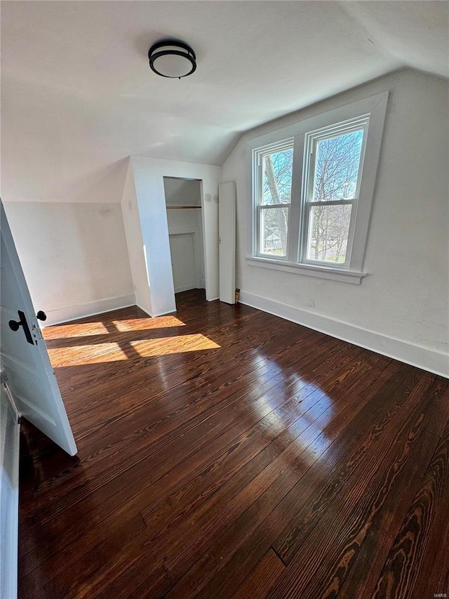 1522 E 5th St, Washington, MO 63090 - additional living space featuring vaulted ceiling, dark wood-style floors, and baseboards
