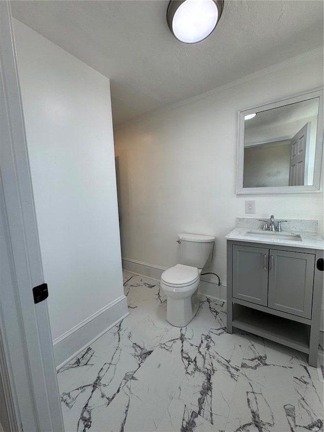 1522 E 5th St, Washington, MO 63090 - bathroom with marble finish floors, baseboards, toilet, vanity, and crown molding