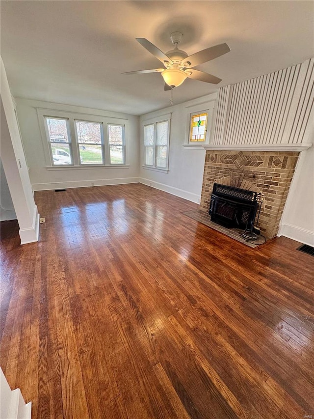 1522 E 5th St, Washington, MO 63090 - unfurnished living room with hardwood / wood-style flooring, baseboards, and a ceiling fan