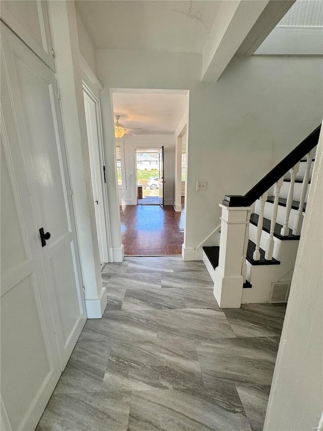 1522 E 5th St, Washington, MO 63090 - hallway with stairway, wood finished floors, and baseboards