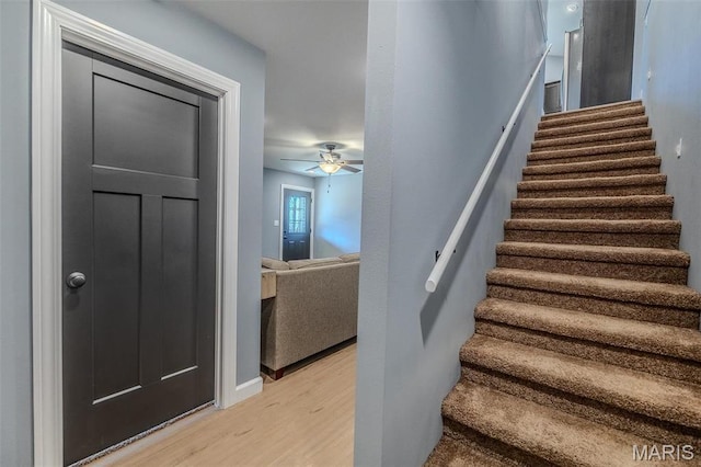 117 Alice Dr, Waynesville, MO 65583 - staircase featuring wood finished floors, ceiling fan, and baseboards