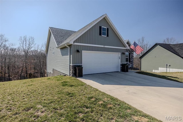 117 Alice Dr, Waynesville, MO 65583 - view of home's exterior featuring concrete driveway, a yard, board and batten siding, and roof with shingles