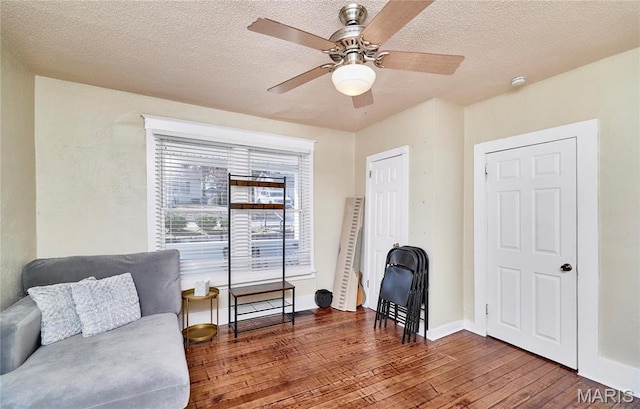 125 Lithia Ave, Saint Louis, MO 63119 - living area featuring wood-type flooring, a ceiling fan, baseboards, and a textured ceiling
