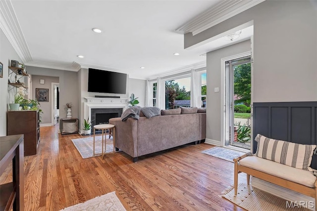 927 Gay Ave, Saint Louis, MO 63130 - living area featuring ornamental molding, light wood-style floors, a fireplace with flush hearth, recessed lighting, and baseboards