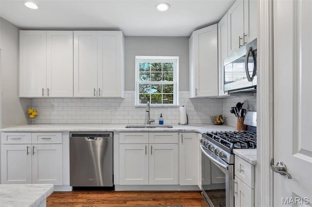 927 Gay Ave, Saint Louis, MO 63130 - kitchen with appliances with stainless steel finishes, a sink, white cabinetry, and recessed lighting