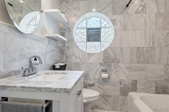 927 Gay Ave, Saint Louis, MO 63130 - full bath featuring a bath, vanity, tile walls, and toilet
