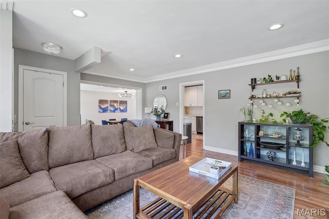 927 Gay Ave, Saint Louis, MO 63130 - living room with recessed lighting, a chandelier, ornamental molding, light wood-type flooring, and baseboards