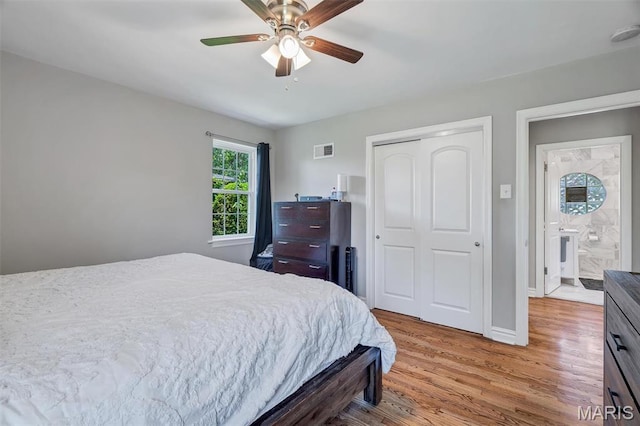 927 Gay Ave, Saint Louis, MO 63130 - bedroom featuring wood finished floors, a closet, baseboards, and ceiling fan