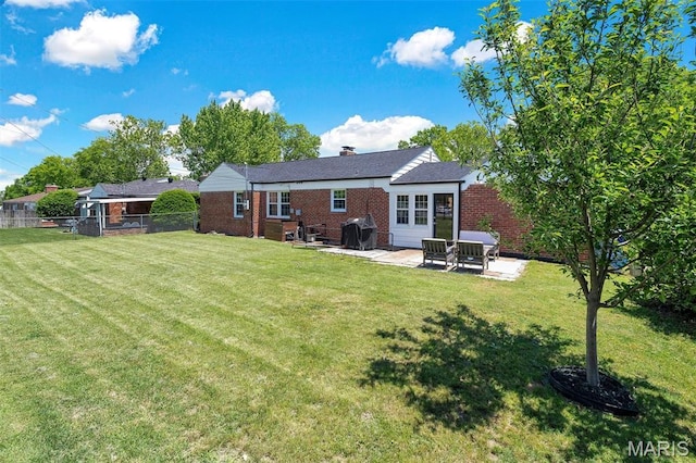927 Gay Ave, Saint Louis, MO 63130 - rear view of house with brick siding, a patio, and a chimney